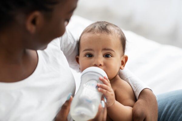 Cute little african american baby drinking from ba 2023 11 27 05 20 30 utc